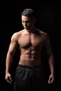 Asian man with bare torso and muscular build.